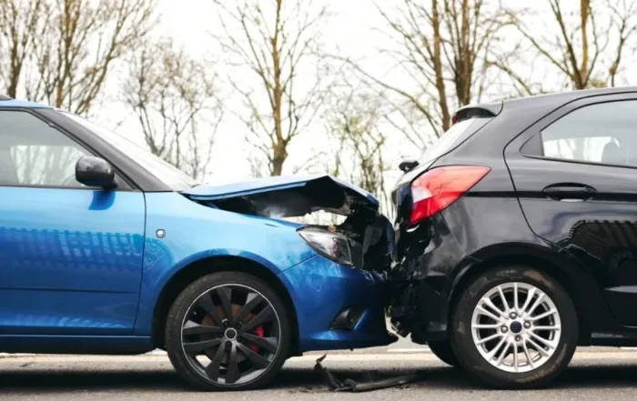 Two damaged cars in the middle of the road