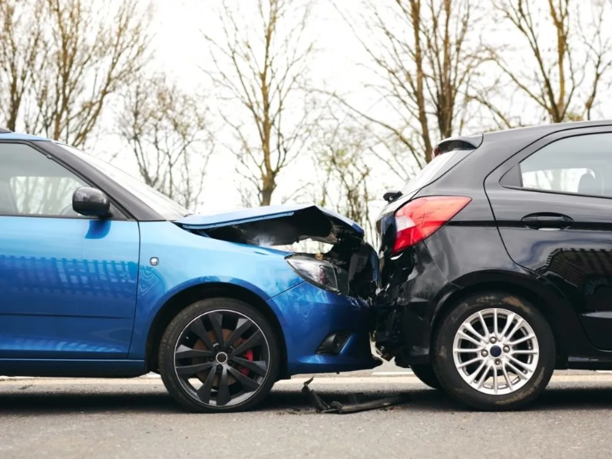 Two damaged cars in the middle of the road