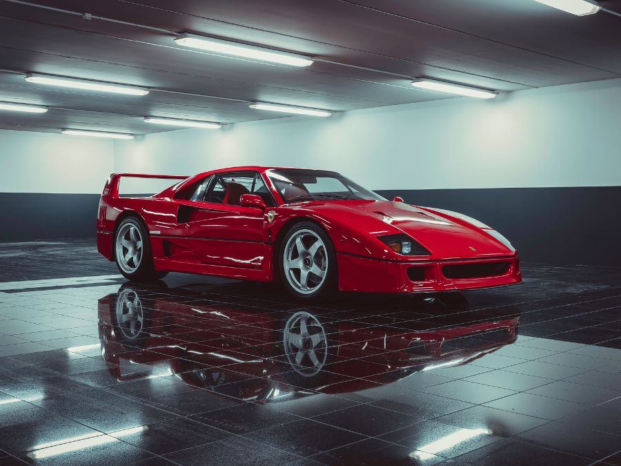 Shiny red sports car in a garage, showing the flawless finish from a professional car wrap