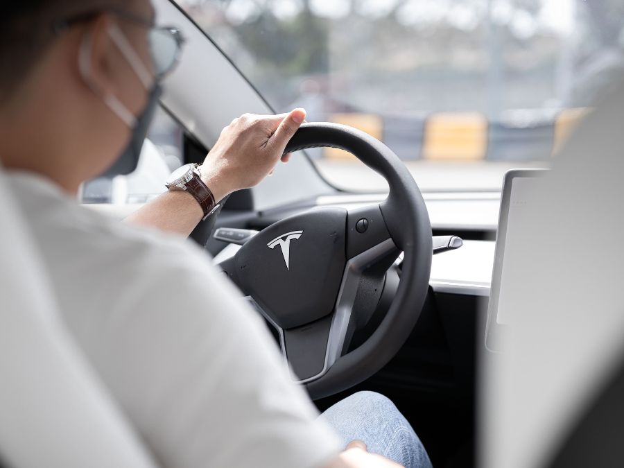 A man driving a Tesla