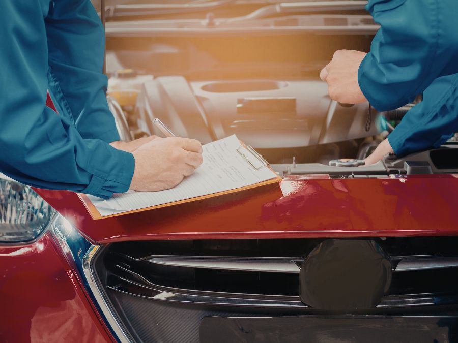 Two expert technicians conduct a thorough car inspection